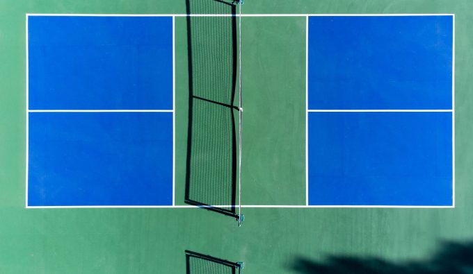 Aerial view of an outdoor pickleball court with blue and green markings
