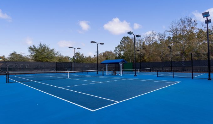 Blue tennis courts with lights